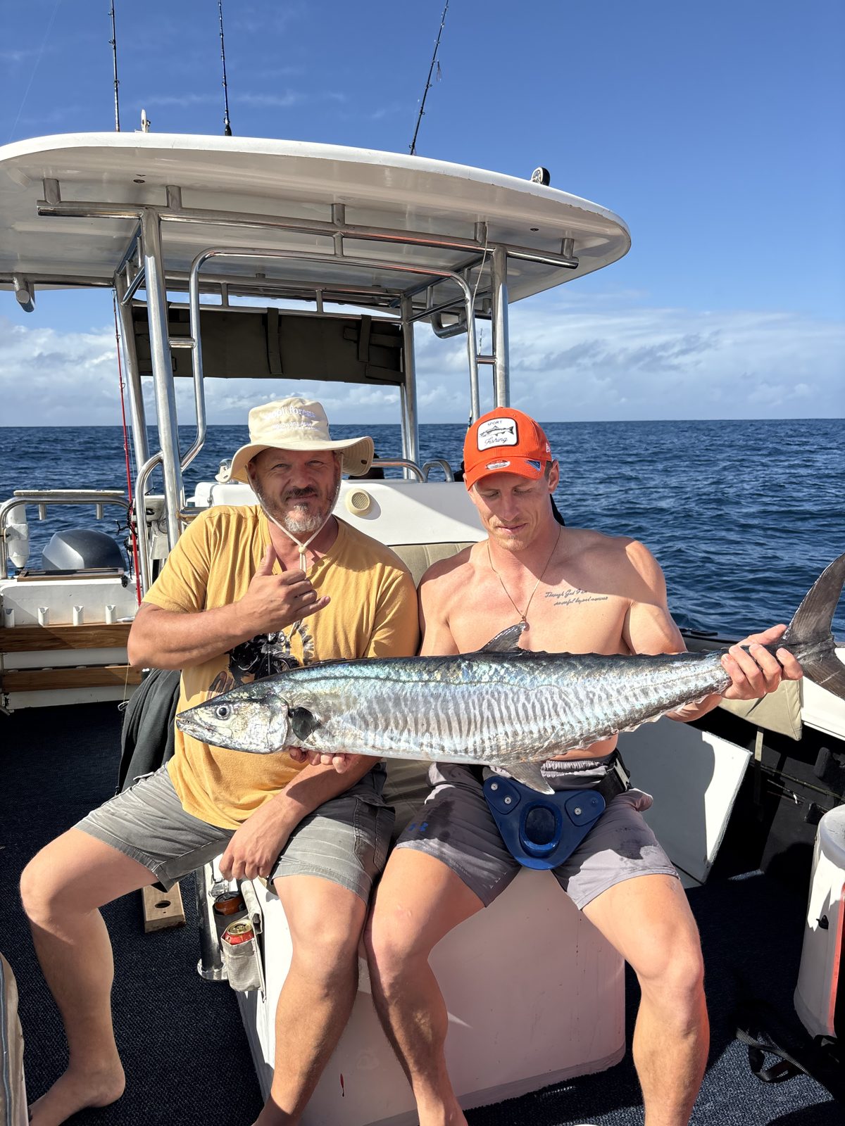 Two anglers on deck with a king mackerel