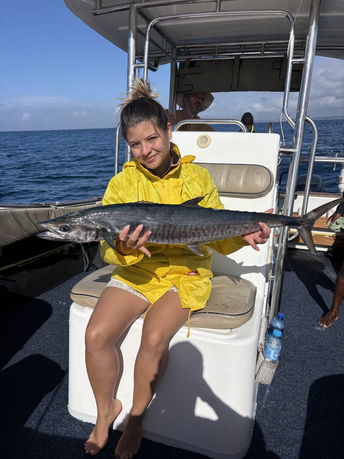 Guest holding a king mackerel on an offshore charter