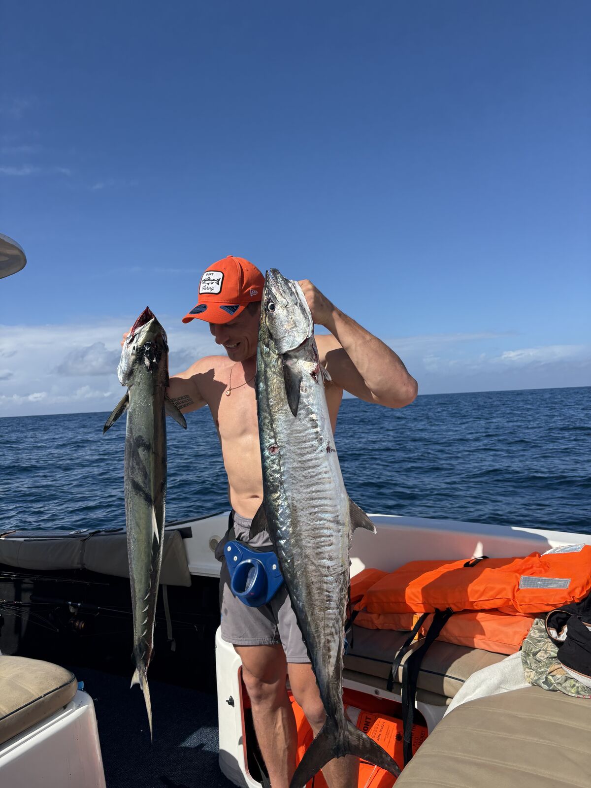 Two anglers with a giant trevally and king mackerel on a multi-day expedition