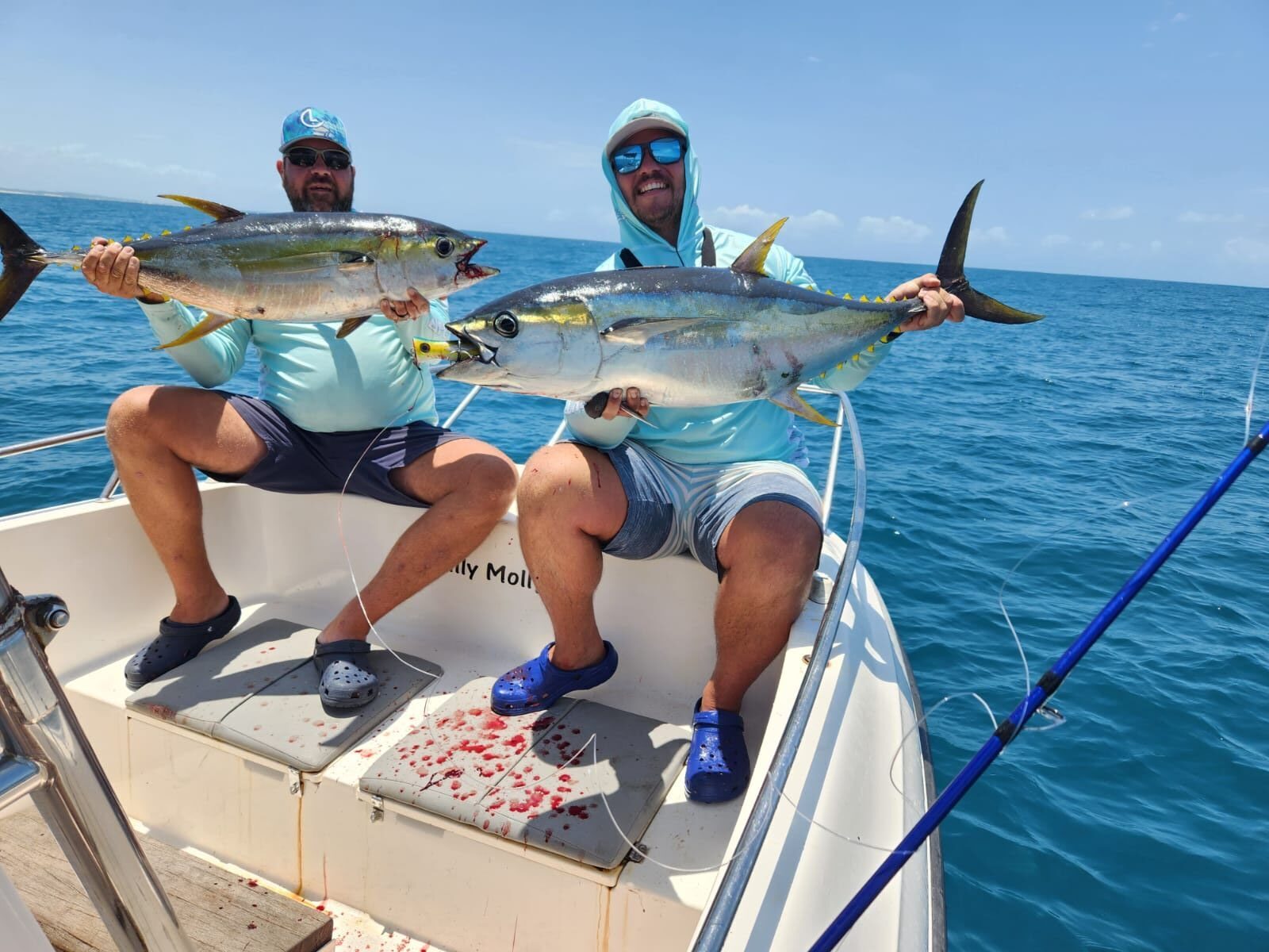 Two anglers with yellowfin tuna on deck